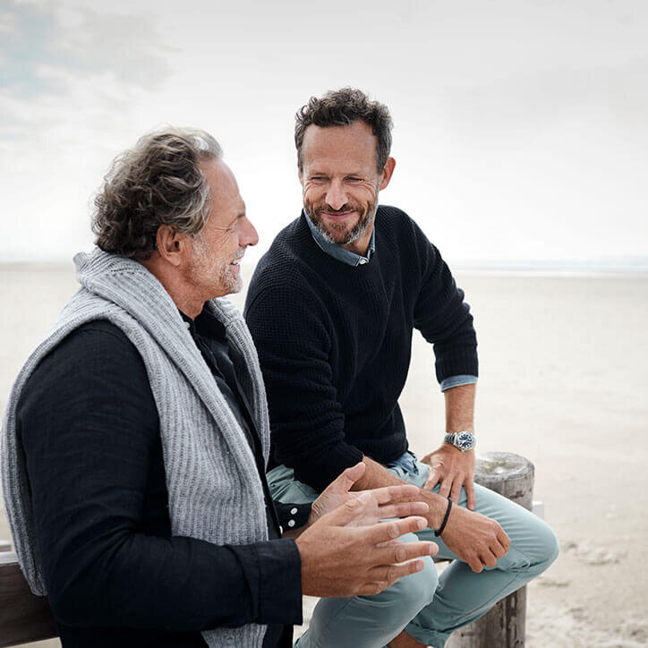 Zwei ältere Männer im Gespräch am Strand | Doppelherz